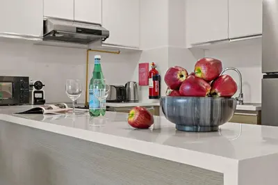 a bowl of apples on a counter in a kitchen at The Smart Concierge - Andalus Jumeirah Golf Estates in Dubai