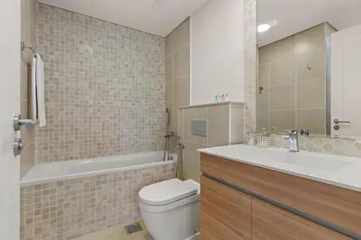 a bathroom with a toilet and a tub and a sink at The Smart Concierge - Andalus Jumeirah Golf Estates in Dubai