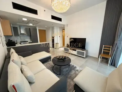 a living room with a couch and a table at Luxurious Two-Bedroom & Living Room Apartment in Dubai