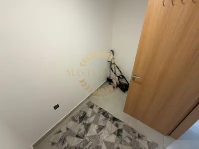 a hallway with a door and a sign on the wall at Luxurious Two-Bedroom & Living Room Apartment in Dubai