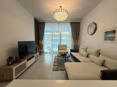 a living room with a couch and a television at Luxurious Two-Bedroom & Living Room Apartment in Dubai