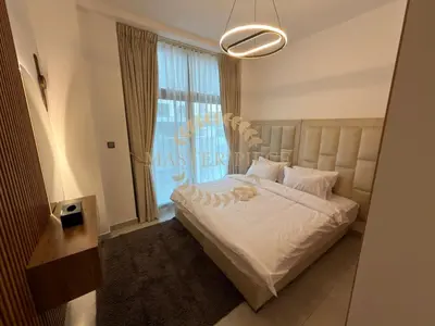 a bedroom with a white bed with a large window at Luxurious Two-Bedroom & Living Room Apartment in Dubai