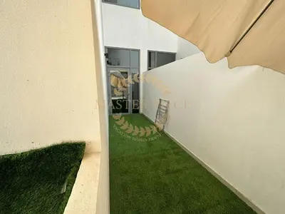 a view of the side of a building with green grass at Pantheon Elysee in Dubai
