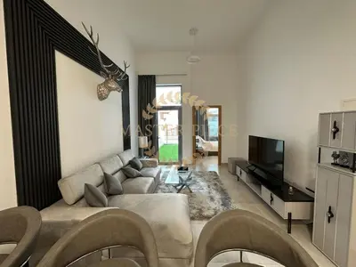 a living room with a couch and a television at Pantheon Elysee in Dubai