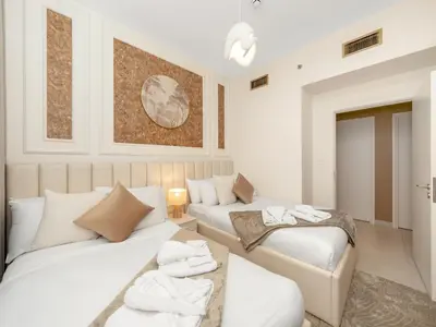 a bedroom with two beds and a couch at Downtown 4BR Apartment for 12 Guests, Burj and Dubai Mall 5 min in Dubai