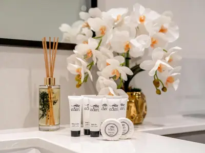 a white counter with a vase with white flowers at Downtown 4BR Apartment for 12 Guests, Burj and Dubai Mall 5 min in Dubai