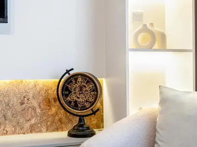 a fan sitting on a table next to a bed at Downtown 4BR Apartment for 12 Guests, Burj and Dubai Mall 5 min in Dubai