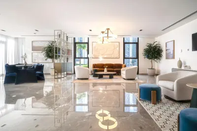 a living room with a couch and a table at Downtown 4BR Apartment for 12 Guests, Burj and Dubai Mall 5 min in Dubai