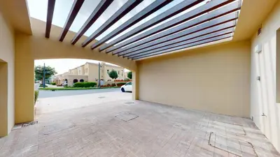 a garage with awning on the side of a building at Vacationer l Serene 2 Bed Villa l Lush Garden l Family Friendly in Nadd Shubayḩ