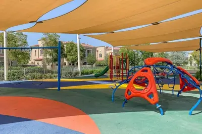 a playground with a slide and a play structure at Vacationer l Serene 2 Bed Villa l Lush Garden l Family Friendly in Nadd Shubayḩ