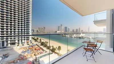 a view of the beach from the balcony of a building at Vacationer l Modern 1 Bed l Private Beach l Pool, Gym Access in Dubai