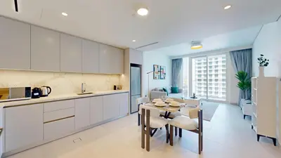 a kitchen and dining room with a table and chairs at Vacationer l Modern 1 Bed l Private Beach l Pool, Gym Access in Dubai