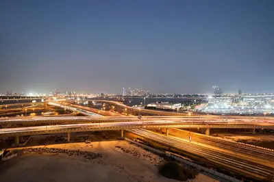 a busy freeway with traffic at night at Chic 1BR at The Bay - Business Bay Near Burj Khalifa & Dubai Mall in Dubai