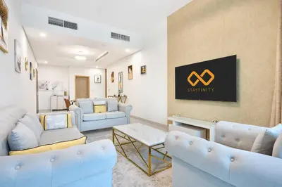 a waiting room with blue furniture and a sign on the wall at Chic 1BR at The Bay - Business Bay Near Burj Khalifa & Dubai Mall in Dubai