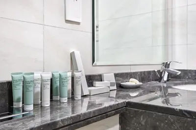 a bathroom with a counter with a bunch of products on it at Chic 1BR at The Bay - Business Bay Near Burj Khalifa & Dubai Mall in Dubai