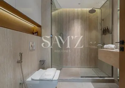a bathroom with a toilet and a sign that says saveholidays at Stylish 2BR in Downtown Views - High Floor 2906 in Dubai
