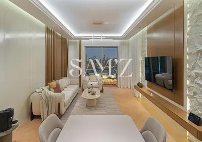 a living room with a couch and a tv at Stylish 2BR in Downtown Views - High Floor 2906 in Dubai