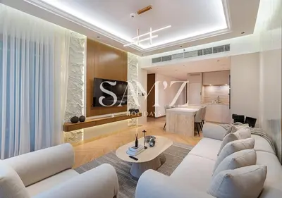 a living room with white couches and a table at Stylish 2BR in Downtown Views - High Floor 2906 in Dubai