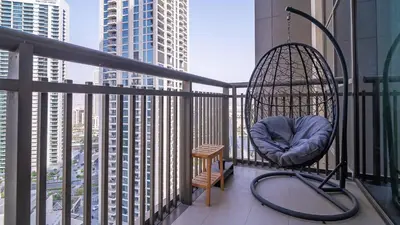 a swing on a balcony with a view of a city at Designer 1BR Dubai Creek Harbour in Dubai