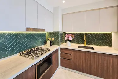 a kitchen with a stove and a counter top at Designer 1BR Dubai Creek Harbour in Dubai