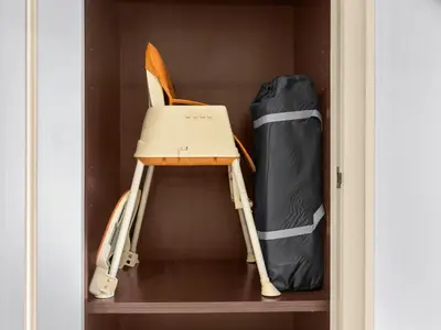 a room with a chair and a bag on a shelf at Luxury 2BR- Pool with Burj View- 5 Min to Dubai Mall in Dubai