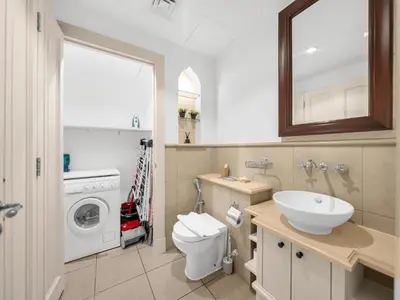a bathroom with a sink and a washing machine at Luxury 2BR- Pool with Burj View- 5 Min to Dubai Mall in Dubai