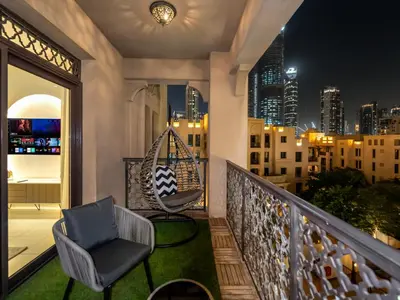 a balcony with two chairs and a swing at Luxury 2BR- Pool with Burj View- 5 Min to Dubai Mall in Dubai