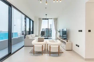a living room with white furniture and large windows at HAVN - 2 Bed with Private Pool, JVC in Dubai