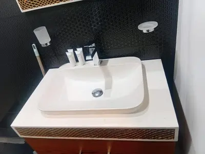 a white sink in a bathroom with a black wall at Studio Hide Away in the Business Bay in Dubai