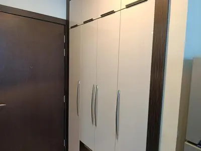 a kitchen with white cabinets and a refrigerator at Studio Hide Away in the Business Bay in Dubai