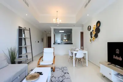 a living room with a couch and a table at Modern 1BR next to Dubai Mall and Burj Khalifa in Dubai