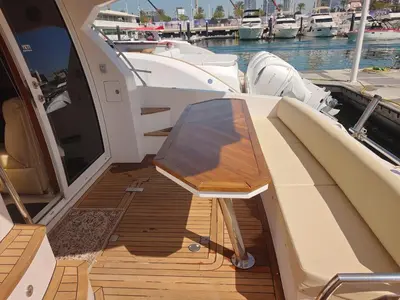 a wooden deck of a boat with a table on it at Luxury yacht Stay Dubai in Dubai
