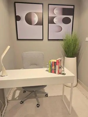 a white desk with a chair and books on it at Fairmont The Palm Luxury Apt 2413 in Dubai