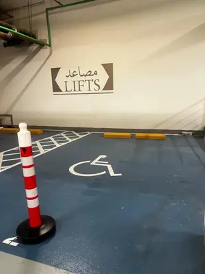 a sign in a parking lot with a handicapped sign at Fairmont The Palm Luxury Apt 2413 in Dubai