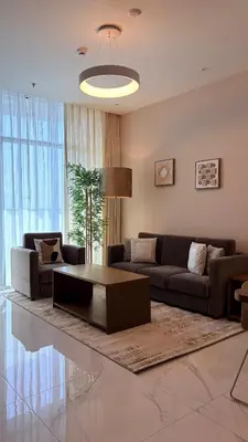 a living room with a couch and a coffee table at Contemporary 1 Bedroom in the Heart of Al Furjan-205 in Dubai