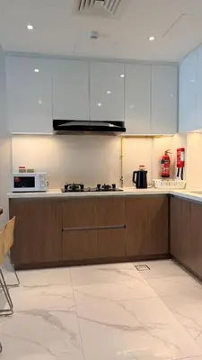 a kitchen with white cabinets and a counter top at Contemporary 1 Bedroom in the Heart of Al Furjan-205 in Dubai