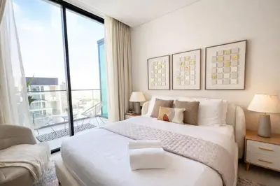 a bedroom with a large bed and a large window at Modern Studio in Binghatti Azure with Pool & Gym in Dubai