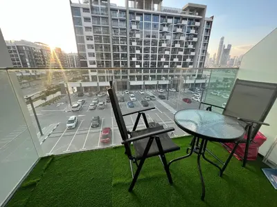 a balcony with a table and chairs on a building at Stylish & Luxe Studio - AZIZI 19 Riviera-Great Views in Dubai