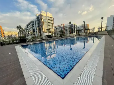 a large swimming pool in a city with buildings at Stylish & Luxe Studio - AZIZI 19 Riviera-Great Views in Dubai