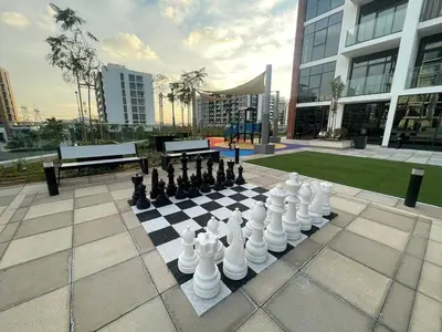 a chess board on a sidewalk with a chessboard at Stylish & Luxe Studio - AZIZI 19 Riviera-Great Views in Dubai