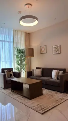 a living room with a couch and a coffee table at Spacious 1BR with Modern Living in Al Furjan-805 in Dubai