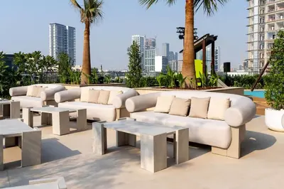 a group of white couches and tables on a patio at Binghatti Royale Luxe 1BR W Private Pool Parking in Dubai