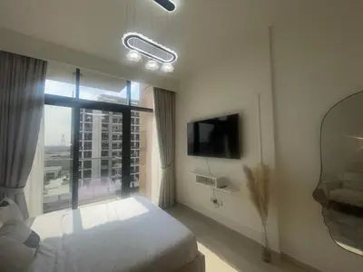a bedroom with a bed and a large window at Studio in Azizi Riviera, 45 in Dubai