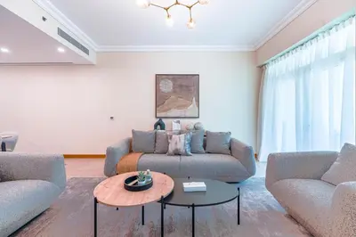 a living room with two couches and a table at HAVN - Spacious 2 Bed in Al Hallawi, Palm Jumeirah in Dubai