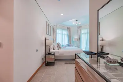 a bedroom with a bed and a large mirror at HAVN - Spacious 2 Bed in Al Hallawi, Palm Jumeirah in Dubai