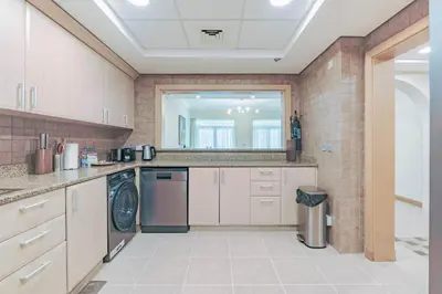 a large kitchen with a washer and dryer at HAVN - Spacious 2 Bed in Al Hallawi, Palm Jumeirah in Dubai