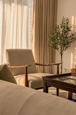 a living room with a chair and a coffee table at 1 Bedroom Deluxe Apartment with Marina Views in Dubai