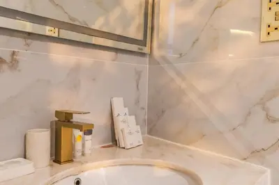 a bathroom with a sink and a mirror at 1 Bedroom Deluxe Apartment with Marina Views in Dubai