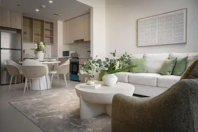 a living room with a couch and a table at Daniels 1BR in Dubai Hills with Park View in Dubai