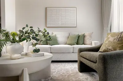 a living room with a couch and a chair and a table at Daniels 1BR in Dubai Hills with Park View in Dubai
